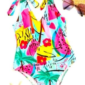 Colorful one piece bathing suit with straps that tie .